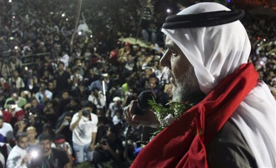 Hassan Meshaima, a Bahraini Shiite opposition leader, speaks to thousands of anti-government protesters hours after he returns from self-imposed exile in London, at the Pearl roundabout in Manama, Bahrain, on Feb. 26. Meshaima was being tried in absentia on charges of trying to overthrow the regime, but the case against him and 24 others was dropped by the King in response to mass protests in the tiny Gulf island kingdom.